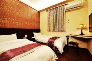Postel nebo postele na pokoji v ubytování King Town Hotel