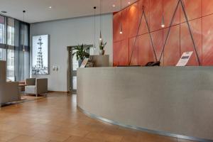 a lobby with a reception desk in a building at Kommerzhotel Köln in Cologne