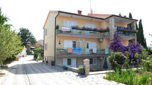 a large apartment building with flowers on the balconies at Villa Bencun in Medulin