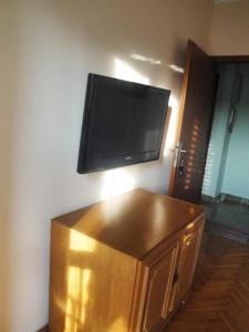 a flat screen tv on top of a wooden cabinet at Villa Bencun in Medulin +6 photos