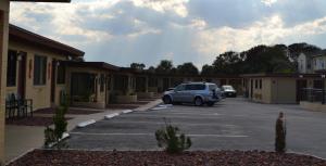 a car parked in a parking lot next to buildings at Atlantic Economy Inn in Daytona Beach