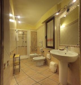 y baño con lavabo y aseo. en B&B Dimora Degli Ulivi, en Muravera