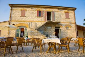 a group of tables and chairs in front of a building at Agriturismo Casa Rossi di Paolo Rossi in Numana +48 photos