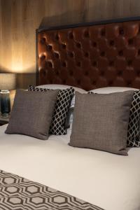 
a bed with two pillows on top of it at The Driftwood Bexhill in Bexhill
