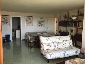 a living room with a couch and a table at Porto San Paolo Sea Villa in Porto San Paolo