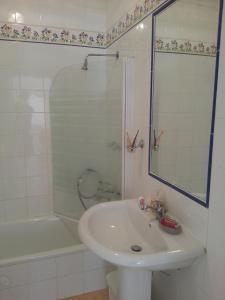 a bathroom with a sink and a shower and a tub at Praia da Luz Apartments in Luz