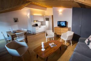 a living room with a couch and a table at Chalet Hotel Régina in Les Gets