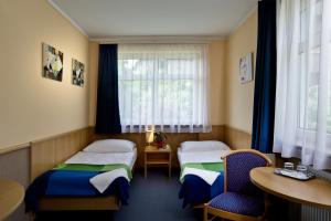 Postel nebo postele na pokoji v ubytování Jagelló Business Hotel