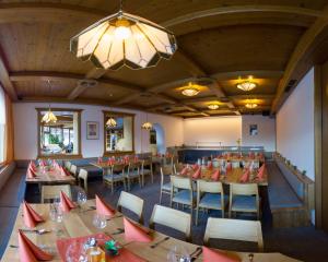 a dining room with tables and chairs and a chandelier at Barbarahof in Werfenweng
