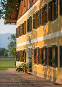 un bâtiment avec des fenêtres et des plantes sur son côté dans l'établissement Weslhof, à Attersee am Attersee