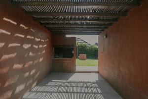 a hallway of a building with a wooden door at Cabañas La Cosecha in San Rafael