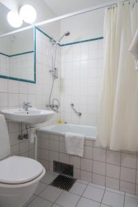 a bathroom with a toilet and a sink and a shower at Teaterhotellet in Malmö