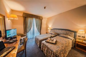 Postel nebo postele na pokoji v ubytování Hotel Valdarno
