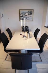 a table with two wine glasses and candles on it at Apartment Mario in Livno