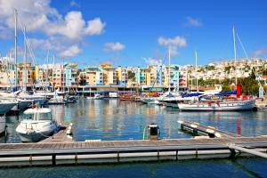 a marina with boats and buildings in the background at Marina Coast Residence in Albufeira
