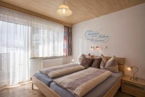a bedroom with a large bed in a room at Haus Enzian in Thiersee