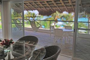 a dining room with a table and chairs on a patio at Las Villas Akumal in Akumal