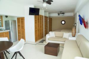 a living room with a couch and a table at Las Villas Akumal in Akumal