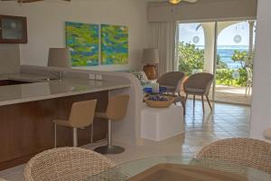 a kitchen and living room with a view of the ocean at Las Villas Akumal in Akumal