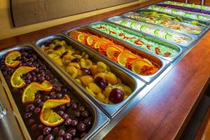 a display of different fruits and vegetables in trays at Hotel SOREA MÁJ in Liptovský Ján