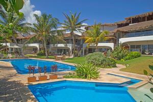 a swimming pool in front of a resort at Las Villas Akumal in Akumal