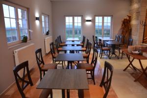 a row of tables and chairs in a room with windows at PS Orion in Wenduine