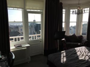 a bedroom with a bed and a window with a view at Queenswood Hotel in Weston-super-Mare
