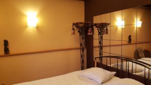 a bedroom with two beds and two lights on the wall at Hospitality Centrum- River in Bucharest