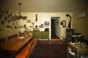 a dining room with a table and chairs and a kitchen at Ca-Jo Bed and Breakfast in Garessio