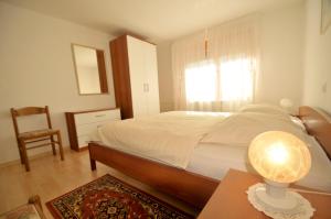 a bedroom with a bed and a table with a lamp at Apartments Wojcicky in Bovec