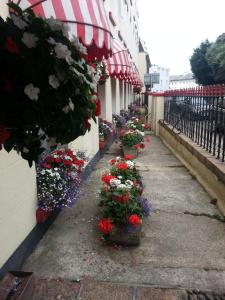 a bouquet of flowers sits on a sidewalk in front of a building at Mornington Hotel in Saint Helier Jersey