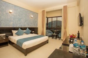 Krevet ili kreveti u jedinici u okviru objekta Tuki Resort Pokhara