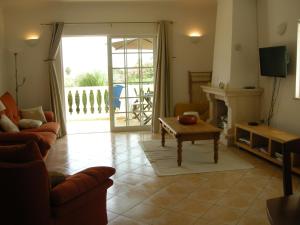 a living room with a couch and a table at Praia da Luz Apartments in Luz