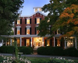 a large red brick building with lights on at Brampton 1860 in Chestertown