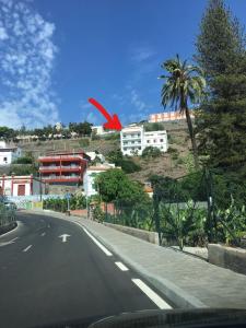 a red object is flying over a road at Apartamentos Noda in Playa de Santiago