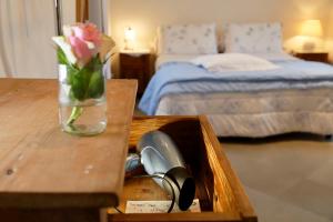 un cajón de madera con un jarrón de flores sobre una mesa en B&B Paradiso n.4, en Siena