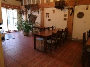 a dining room with a table and chairs at Dom Mysliwski in Kobyłka +20 photos