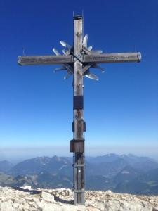 a wooden cross on the top of a mountain at Alte Zimmerei - Lofer in Lofer