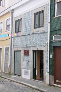 a building with a blue tiled facade on a street at Hostel Eleven in Esposende