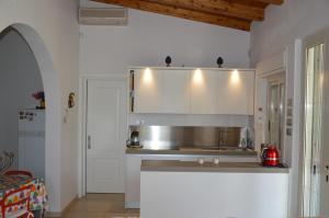 a kitchen with a sink and a counter top at Villa Paola in Fontane Bianche