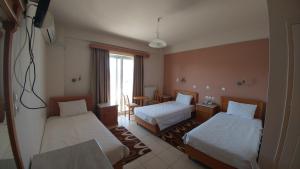 Voodi või voodid majutusasutuse Hotel Lykeon toas