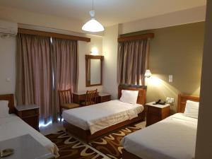 Voodi või voodid majutusasutuse Hotel Lykeon toas