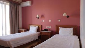 Voodi või voodid majutusasutuse Hotel Lykeon toas