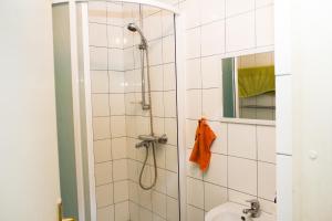 a bathroom with a shower with a toilet and a sink at Hostel Oras in Vilnius