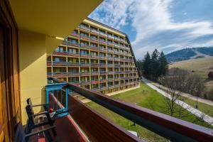 a balcony of a building with a view of a field at Hotel SOREA ĽUBOVŇA in Stará Ľubovňa