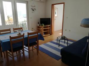 a living room with a table and a couch at Apartmani Igor in Makarska