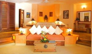 
a living room filled with furniture and decorations at Villa Carolina Boutique Hotel ADULTS ONLY in Zihuatanejo

