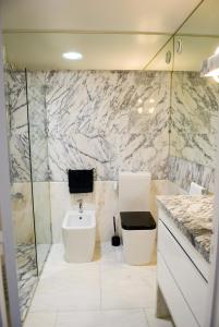 a bathroom with a sink and a toilet in it at Porto Sea Apartments in Matosinhos