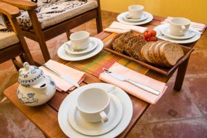 a table with plates and cups and a tray of food at Apartment Vita in Rab