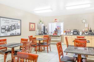 un restaurante con mesas y sillas y una cocina en Super 8 by Wyndham Grants Pass, en Grants Pass